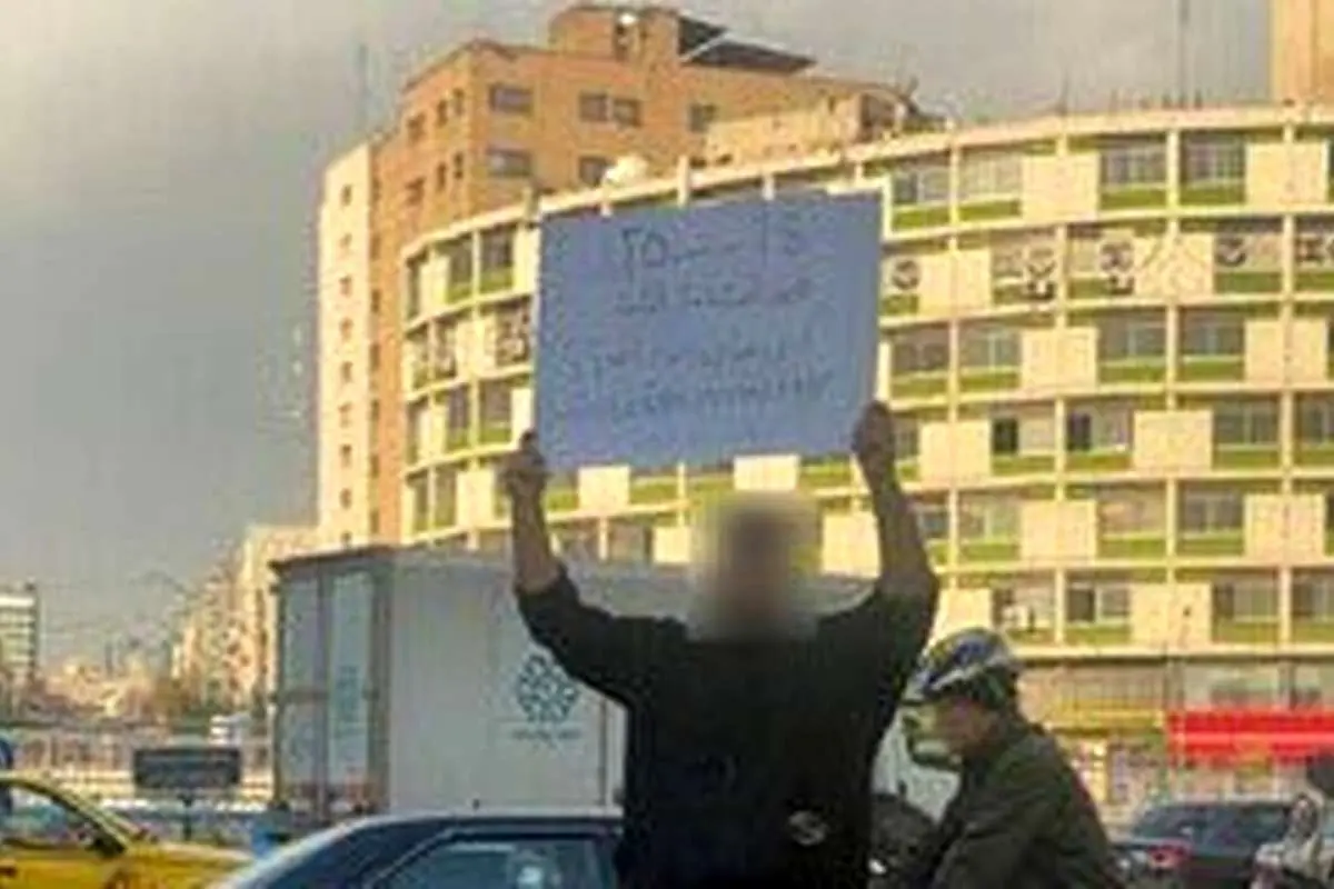 (تصویر) پلاکارد اعتراضی جوان ایرانی: مرده و زندهی من برای کسی فرق میکنه؟!