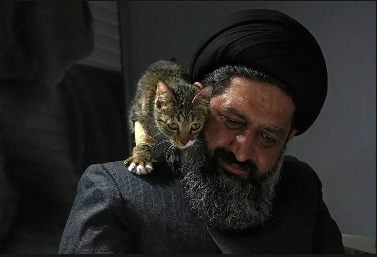 (عکس) گربه زخمی بر شانه روحانی ایرانی حامی حیوانات