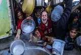 تصاویری دردناک از پدری فلسطینی و فرزندش در سطل زباله در غزه
